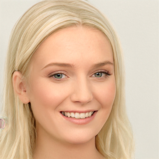 Joyful white young-adult female with long  blond hair and blue eyes