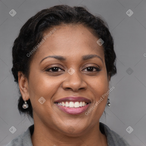 Joyful black adult female with medium  brown hair and brown eyes