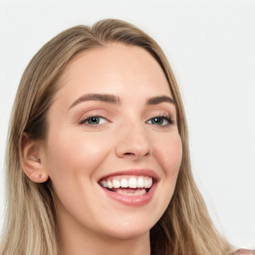 Joyful white young-adult female with long  brown hair and blue eyes