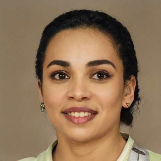 Joyful latino young-adult female with short  black hair and brown eyes