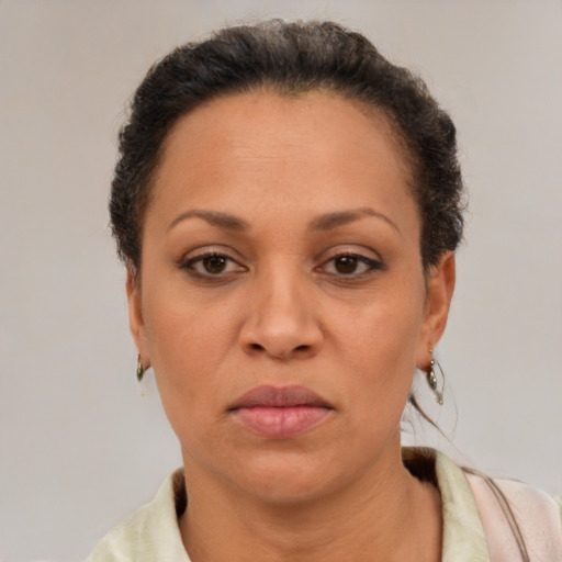 Joyful latino adult female with short  brown hair and brown eyes