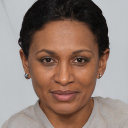 Joyful black adult female with short  black hair and brown eyes
