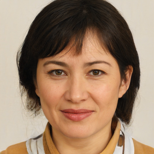 Joyful white adult female with medium  brown hair and brown eyes