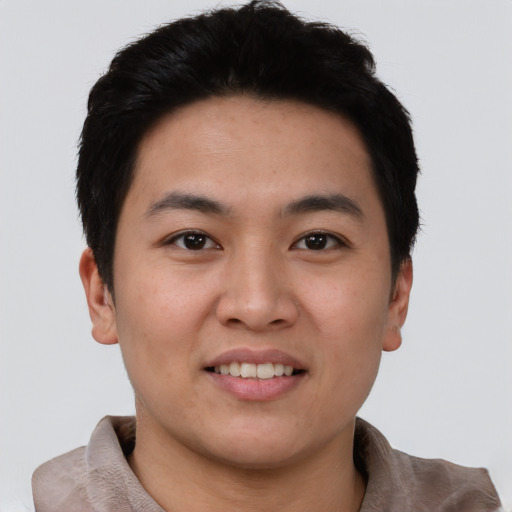 Joyful asian young-adult male with short  black hair and brown eyes