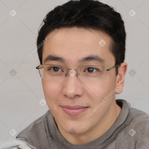 Joyful asian young-adult male with short  brown hair and brown eyes