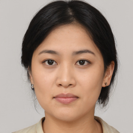 Joyful asian young-adult female with medium  black hair and brown eyes