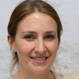 Joyful white adult female with medium  brown hair and brown eyes