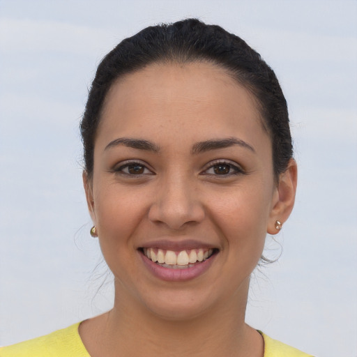 Joyful latino young-adult female with short  brown hair and brown eyes