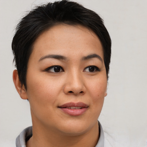 Joyful asian young-adult female with short  brown hair and brown eyes