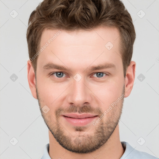 Joyful white young-adult male with short  brown hair and grey eyes