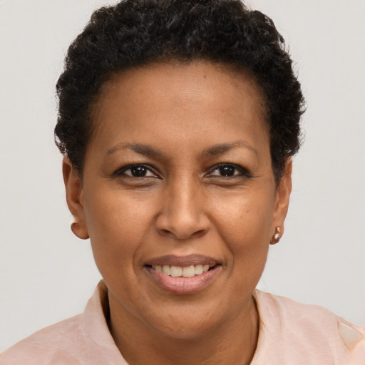 Joyful black young-adult female with short  brown hair and brown eyes