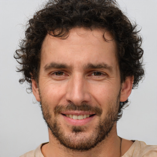 Joyful white adult male with short  brown hair and brown eyes