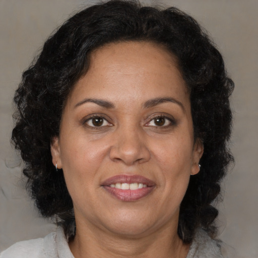 Joyful black adult female with medium  brown hair and brown eyes