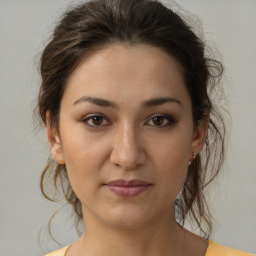 Joyful white young-adult female with medium  brown hair and brown eyes