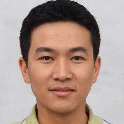 Joyful asian young-adult male with short  black hair and brown eyes