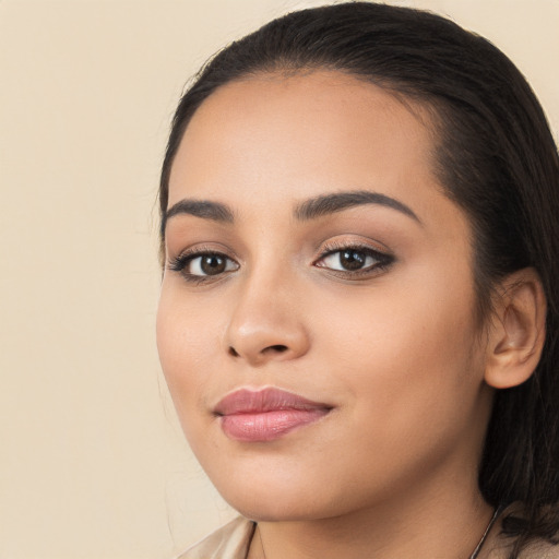 Joyful latino young-adult female with long  brown hair and brown eyes