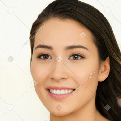 Joyful white young-adult female with long  brown hair and brown eyes