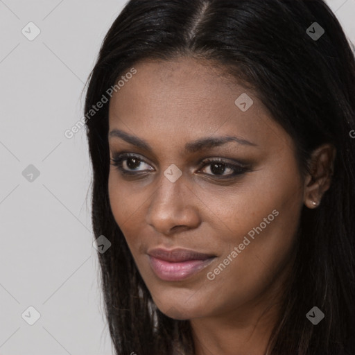 Joyful black young-adult female with long  brown hair and brown eyes