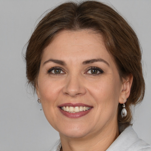 Joyful white adult female with medium  brown hair and brown eyes