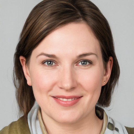 Joyful white young-adult female with medium  brown hair and blue eyes