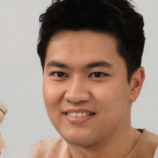 Joyful asian young-adult male with short  brown hair and brown eyes