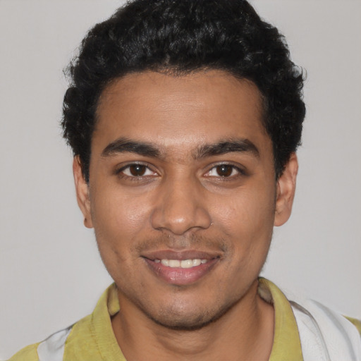 Joyful latino young-adult male with short  black hair and brown eyes