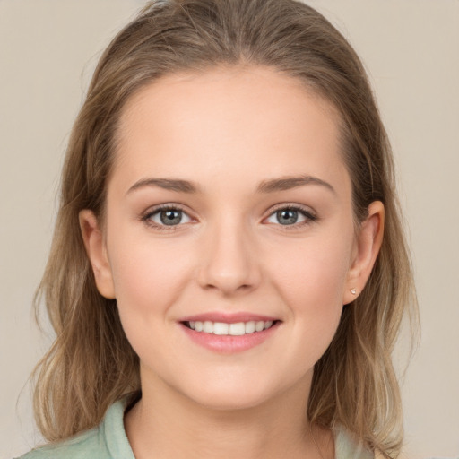 Joyful white young-adult female with long  brown hair and grey eyes