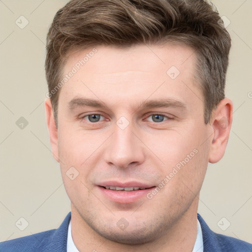 Joyful white young-adult male with short  brown hair and grey eyes