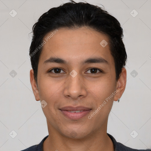 Joyful latino young-adult male with short  black hair and brown eyes