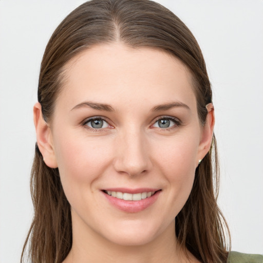 Joyful white young-adult female with long  brown hair and grey eyes