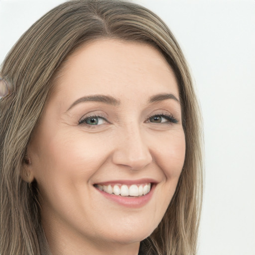 Joyful white young-adult female with long  brown hair and green eyes