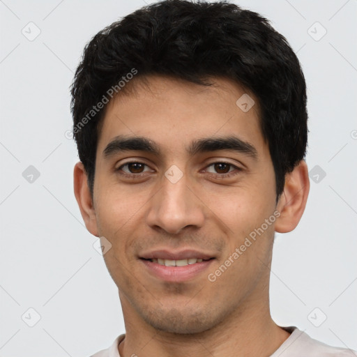 Joyful white young-adult male with short  black hair and brown eyes