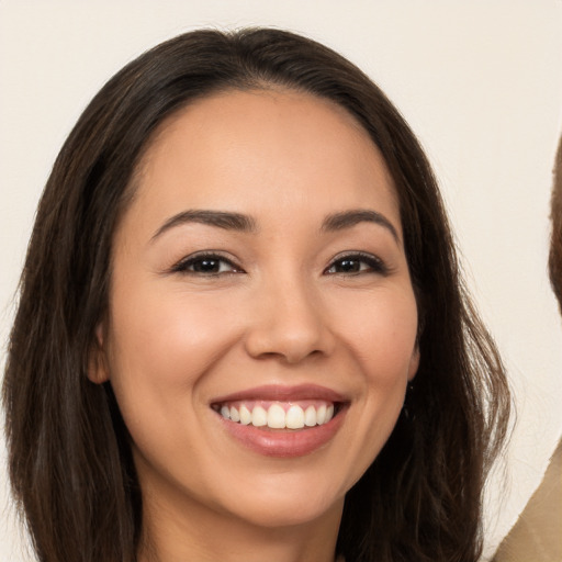 Joyful white young-adult female with long  brown hair and brown eyes