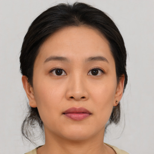 Joyful asian young-adult female with medium  brown hair and brown eyes