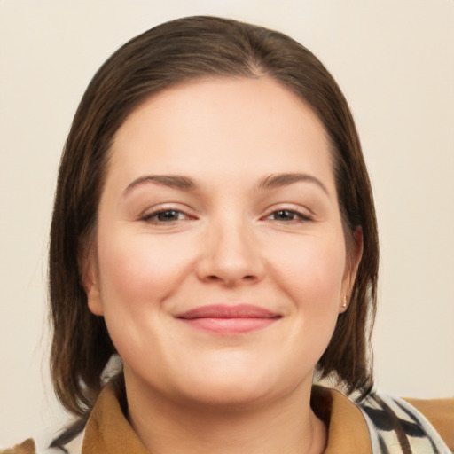 Joyful white young-adult female with medium  brown hair and brown eyes