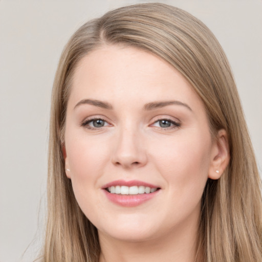 Joyful white young-adult female with long  brown hair and grey eyes