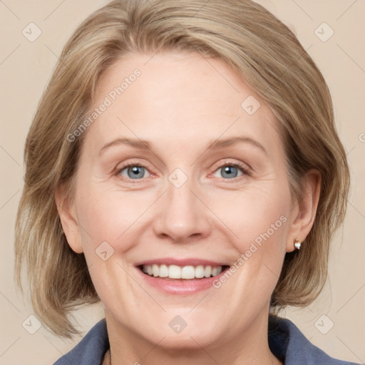 Joyful white adult female with medium  brown hair and blue eyes