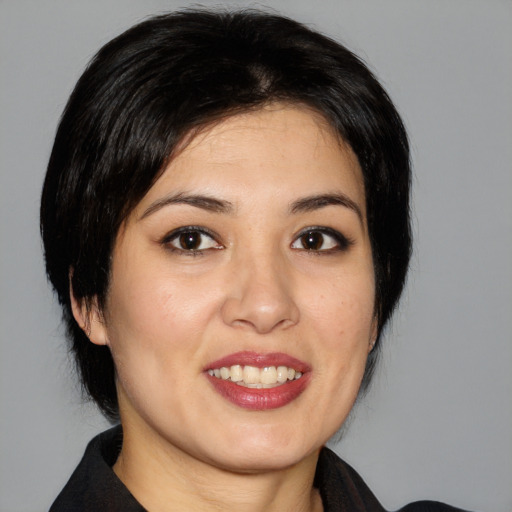 Joyful asian young-adult female with medium  black hair and brown eyes