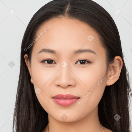 Joyful asian young-adult female with long  brown hair and brown eyes