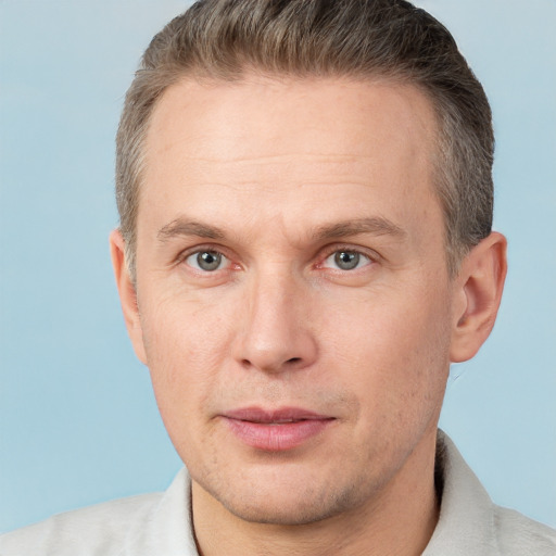 Joyful white adult male with short  brown hair and grey eyes