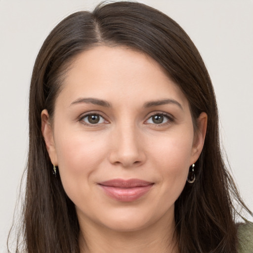 Joyful white young-adult female with long  brown hair and brown eyes