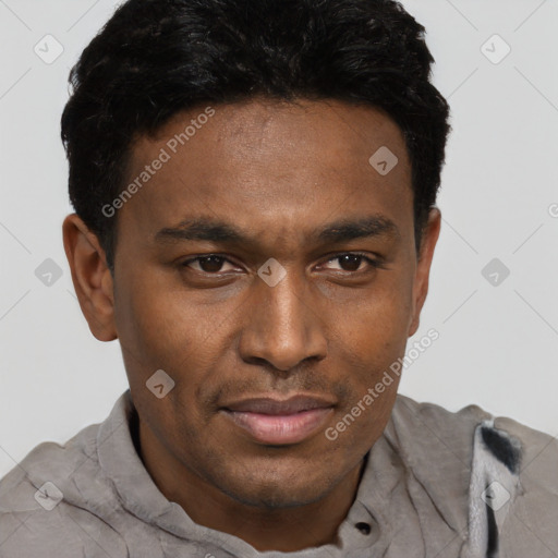 Joyful black adult male with short  brown hair and brown eyes