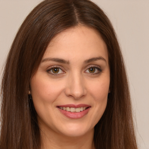 Joyful white young-adult female with long  brown hair and brown eyes