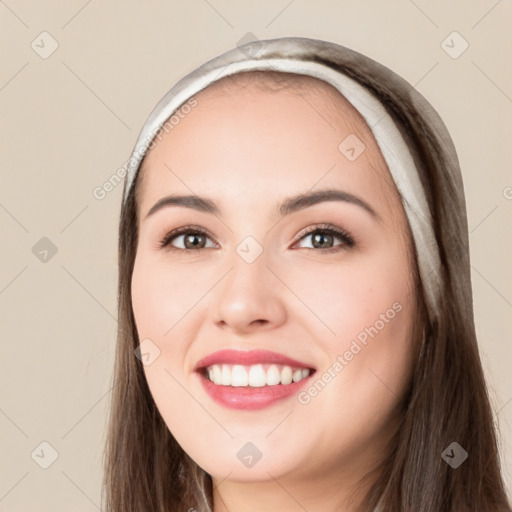 Joyful white young-adult female with long  black hair and brown eyes