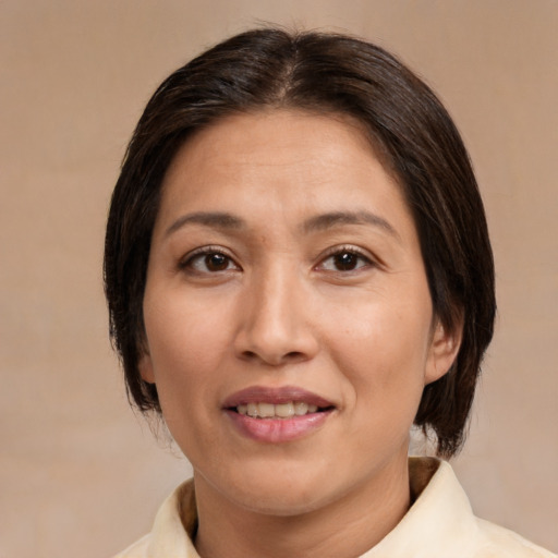 Joyful white adult female with medium  brown hair and brown eyes