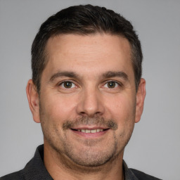 Joyful white adult male with short  brown hair and brown eyes