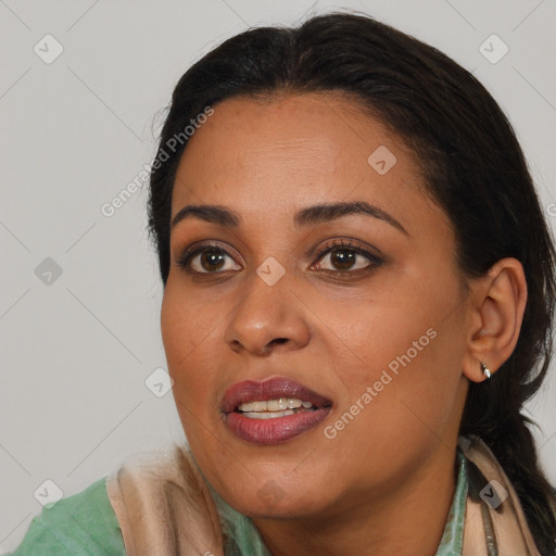 Joyful black young-adult female with long  brown hair and brown eyes