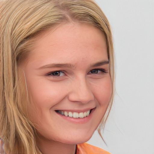 Joyful white young-adult female with long  brown hair and blue eyes