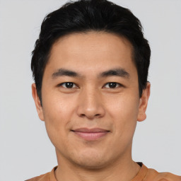 Joyful asian young-adult male with short  black hair and brown eyes