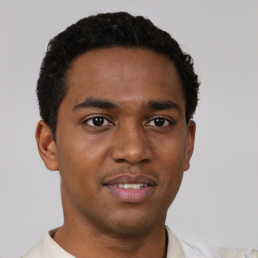 Joyful black young-adult male with short  brown hair and brown eyes